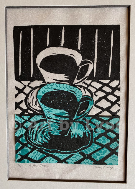 Framed relief print of two tea cups.