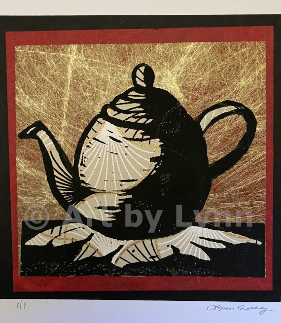 Framed relief print of a teapot.